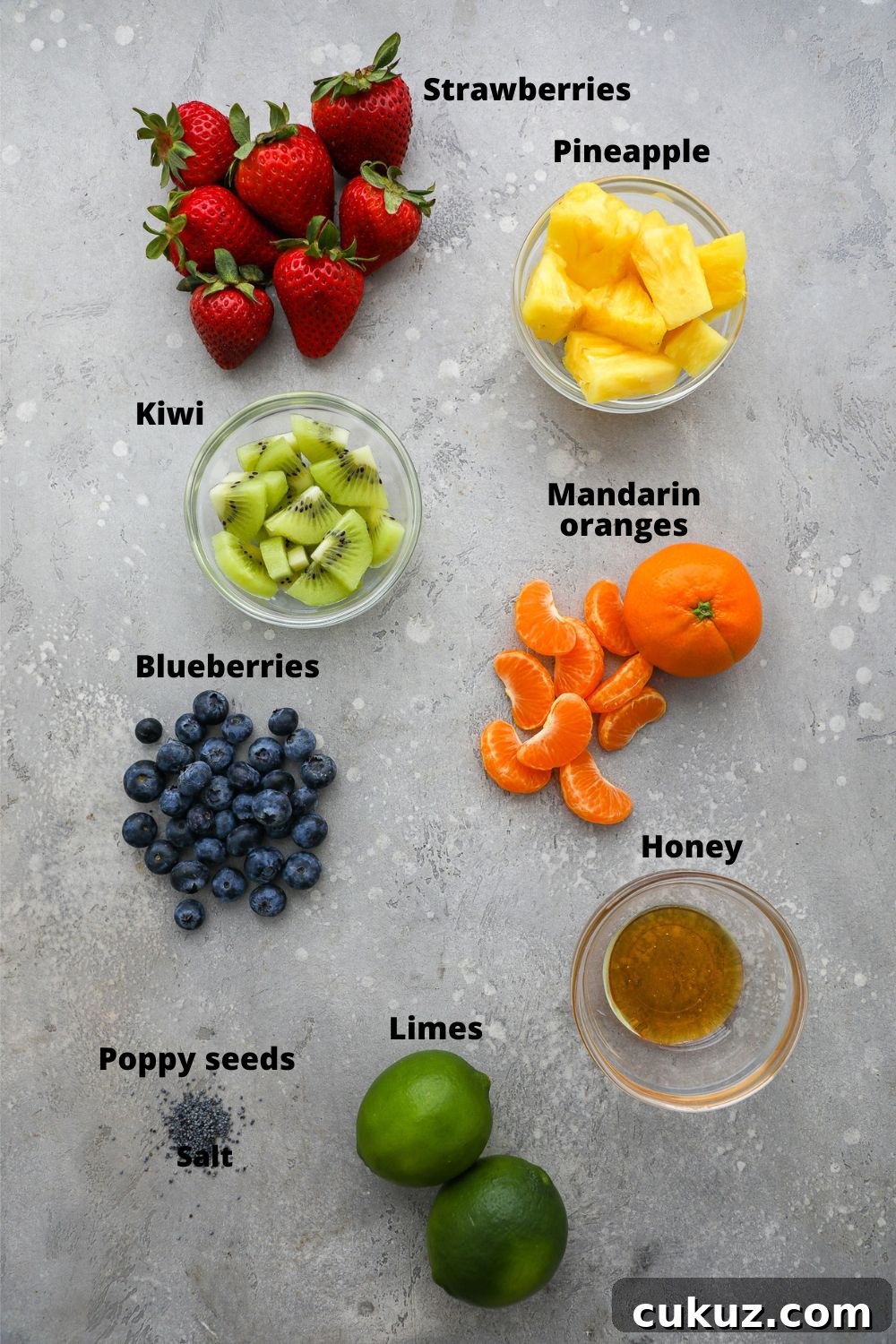 Ingredients used to make a fresh fruit salad with honey lime poppy seed dressing