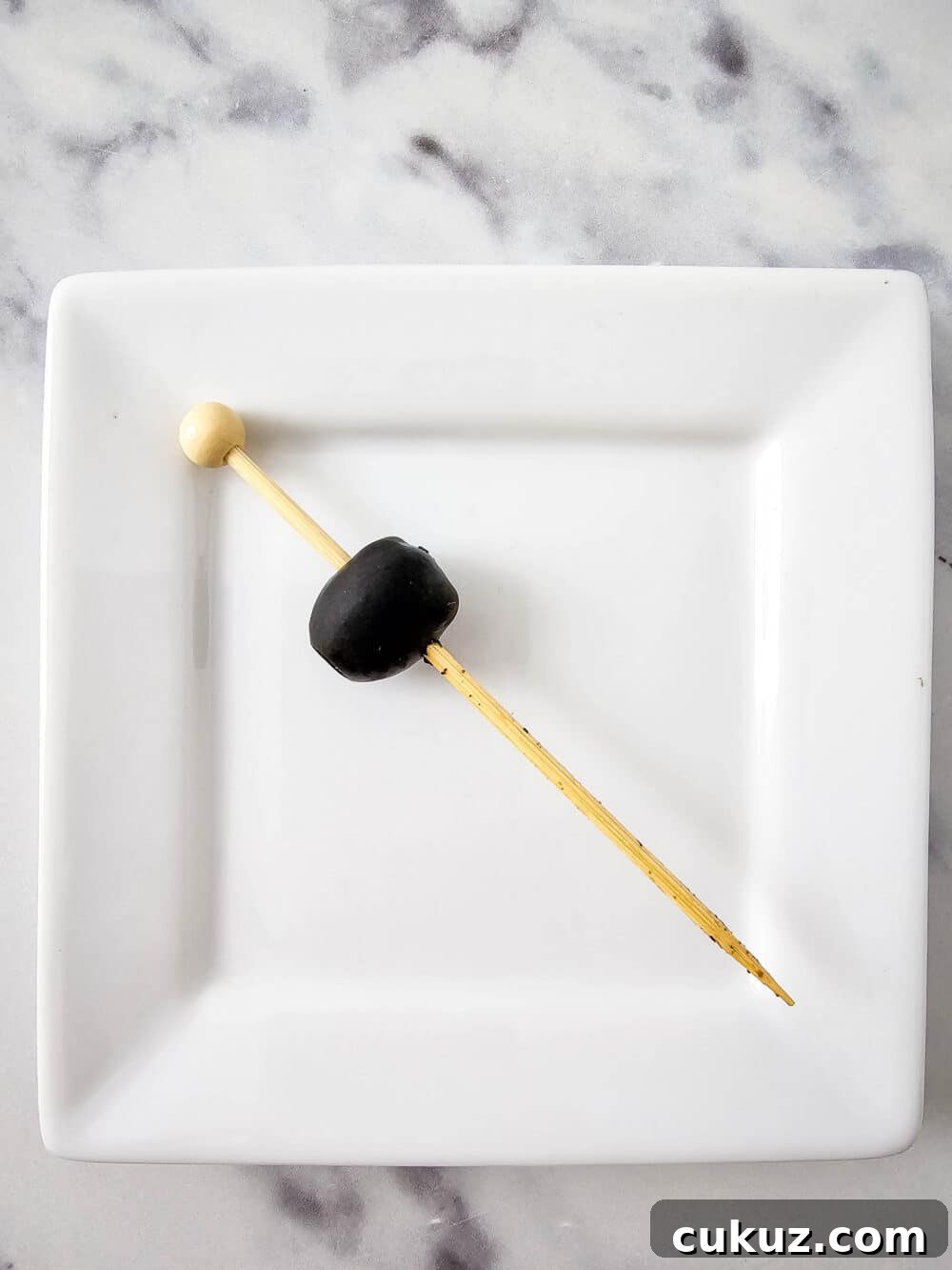one olive on a skewer
