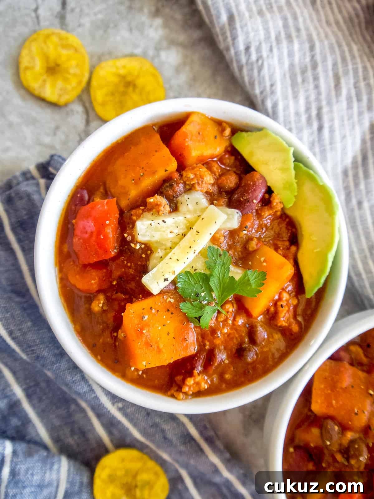 Butternut squash chili with ground turkey in two bowls.