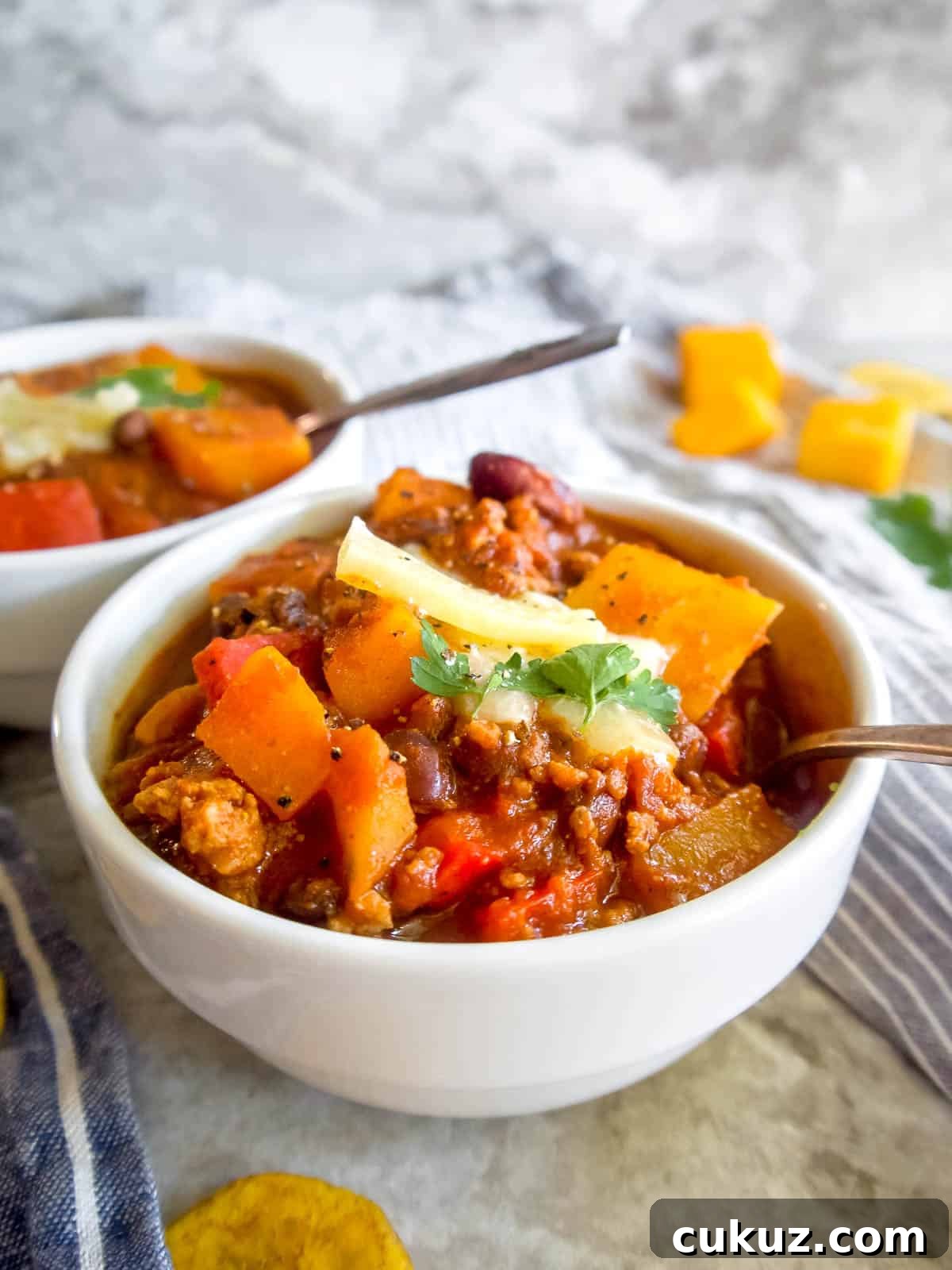 Butternut squash and black bean chili in two bowls.