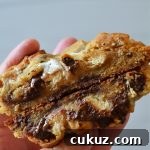 author holding a split open s'mores deep dish cookie on a white background