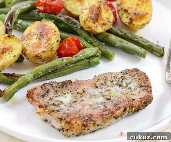 Italian Pork Chop Sheet Pan Dinner on a plate close up.