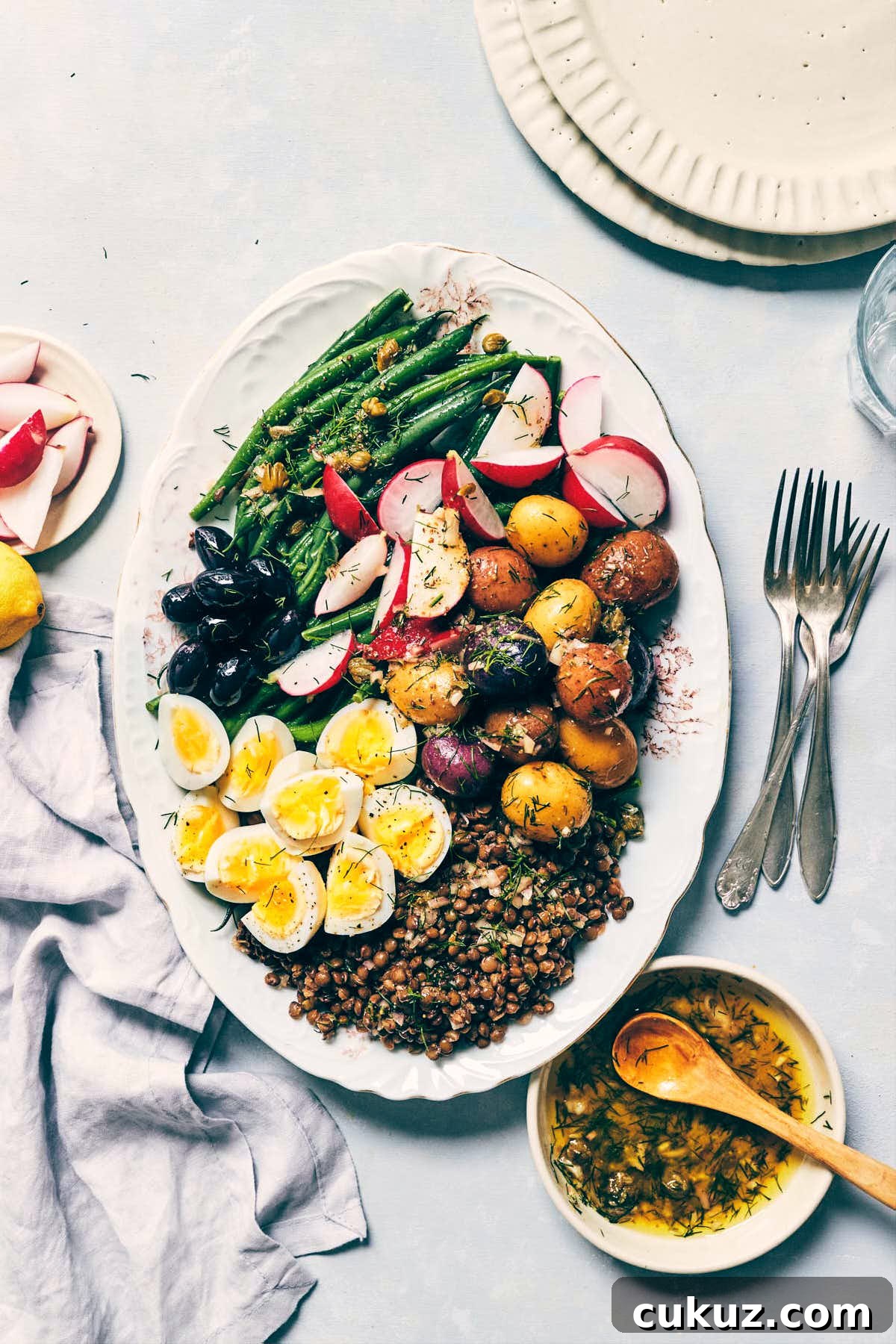 Nicoise salad with eggs, roasted potatoes, green beans, lentils and fresh radishes