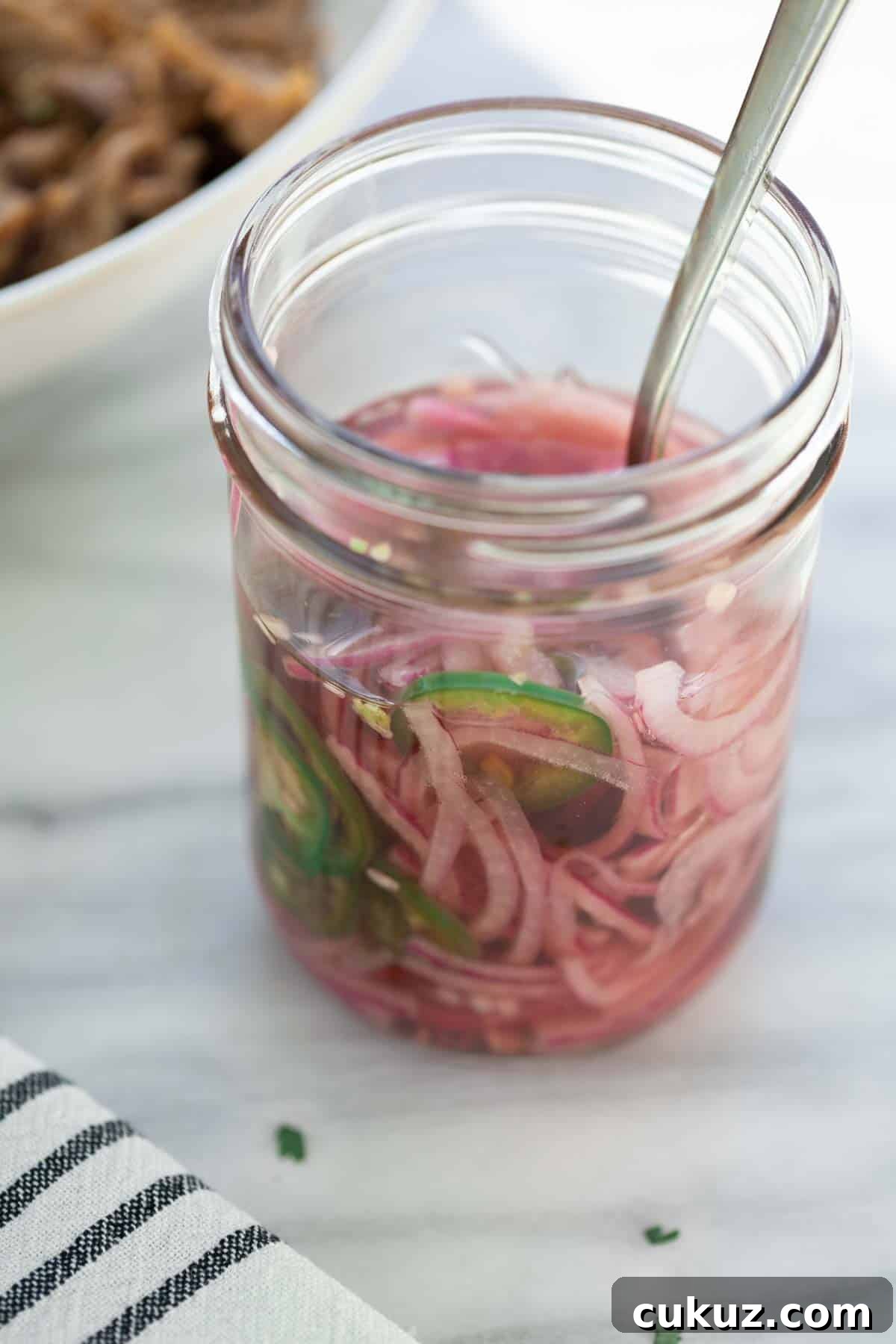 Slow-Cooker Sweet Pork Tacos Recipe for Flavorful Weeknight Meals 7 pickled onions in mason jar with fork on marble background