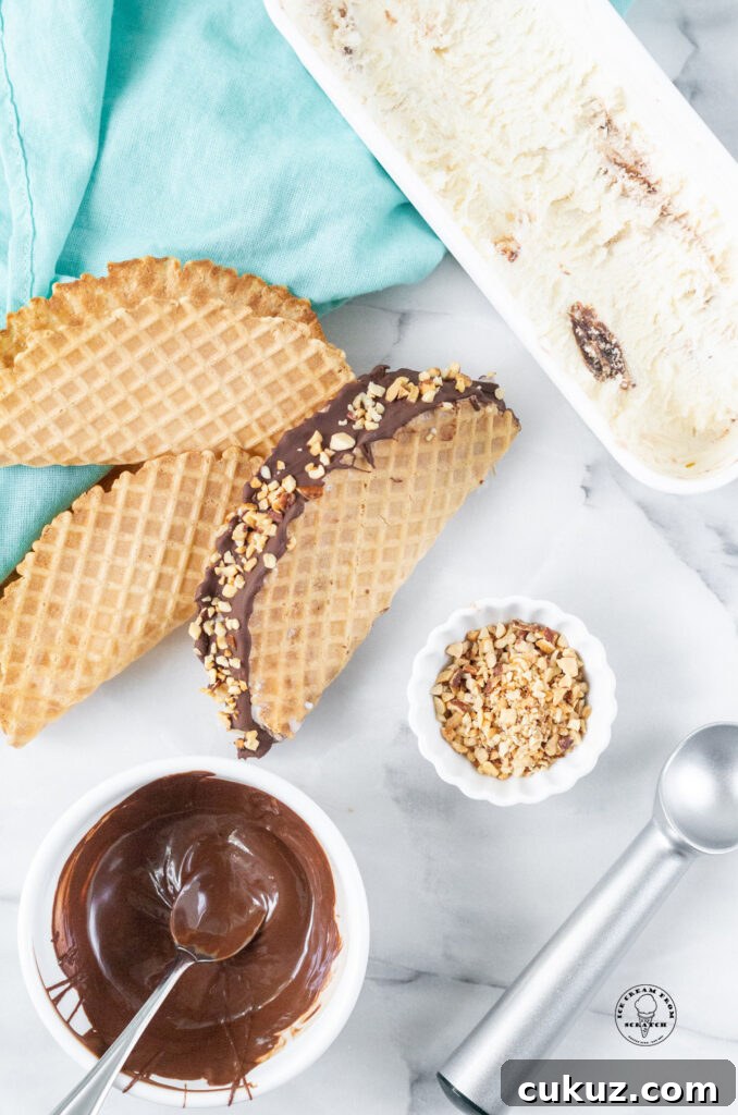 top down view of a choco taco next to melted chocolate and chopped nuts