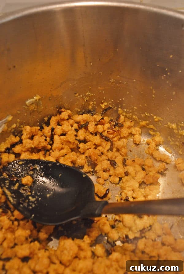 Some brown chunks frying in a pot
