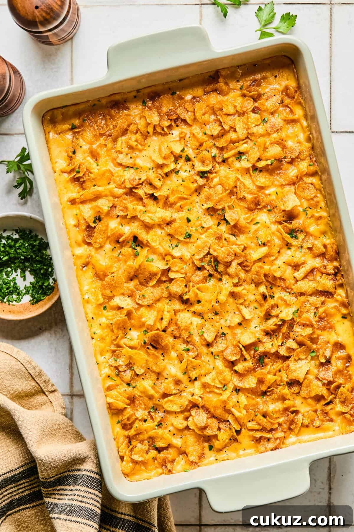 Cheesy hashbrown casserole in a large white baking dish.