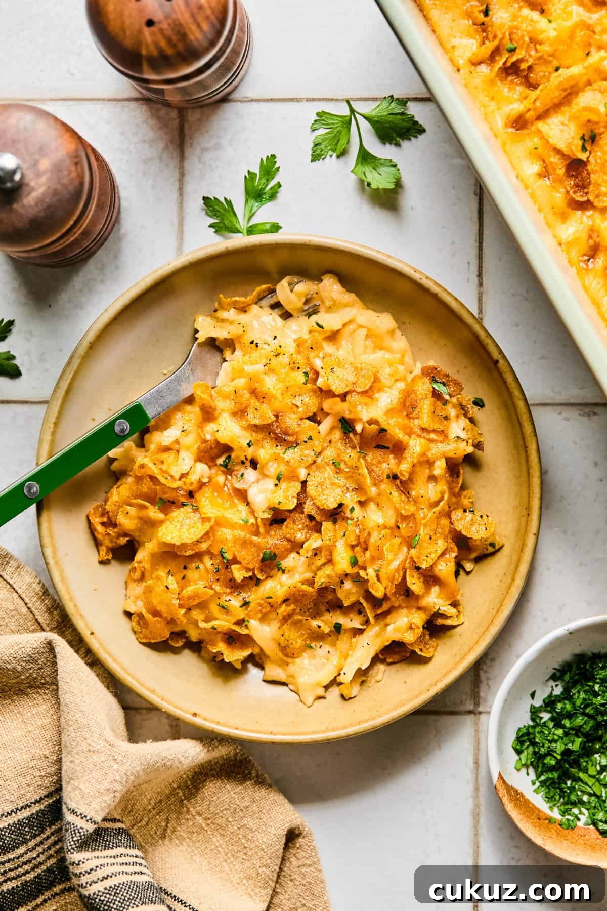 Cheesy hashbrown casserole on a plate, ready to eat.