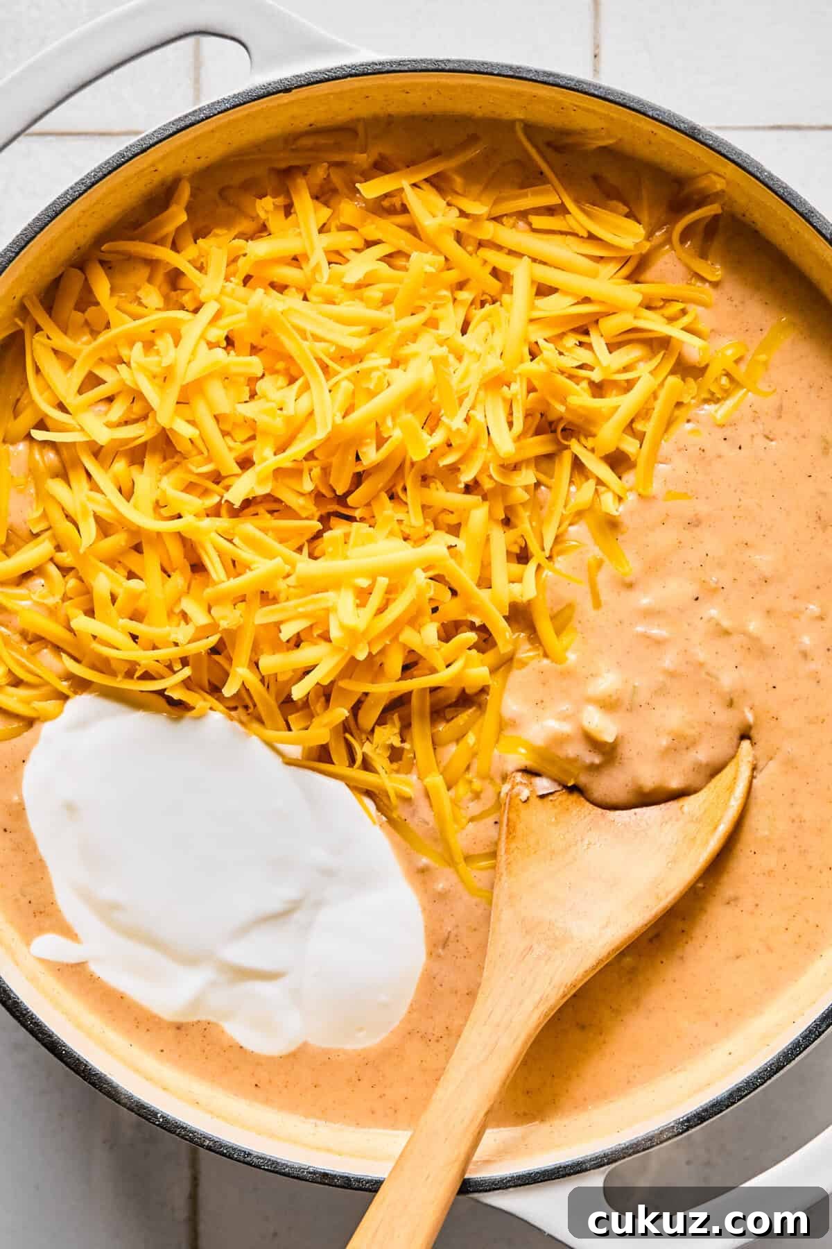 Blended cottage cheese and sharp cheddar in the pan to create the hashbrown casserole sauce.