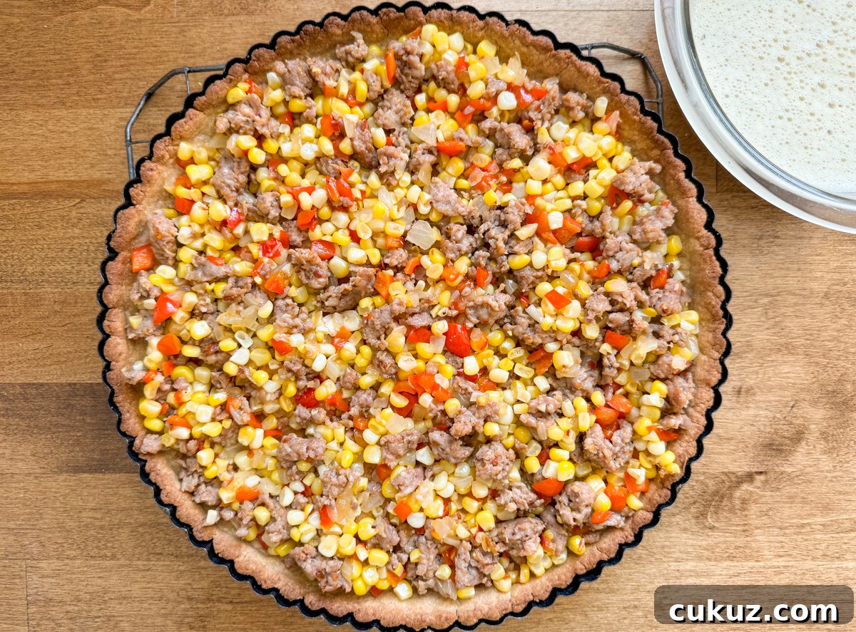 Sausage and Corn Pie with Quick Press‑In Pan Crust 8 sausage pie crust with meat and vegetable filling and egg mixture in a bowl to be added