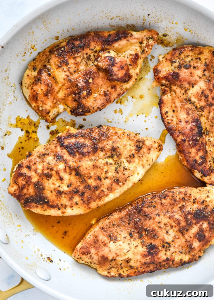 Juicy Thin-Sliced Stovetop Chicken Breasts in 20 Minutes 6 thin sliced stovetop chicken breasts just cooked in a pan.