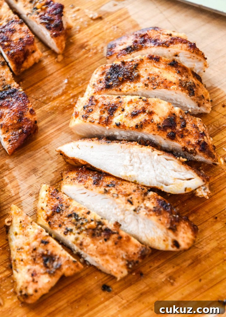 Juicy Thin-Sliced Stovetop Chicken Breasts in 20 Minutes 10 sliced cooked chicken breast on a cutting board.