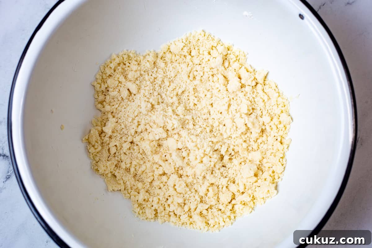 Crumbled mixture for crust in mixing bowl for delicious lemon bars.