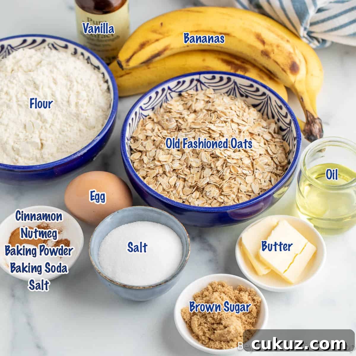 Small bowls filled with ingredients for making banana oatmeal muffins.