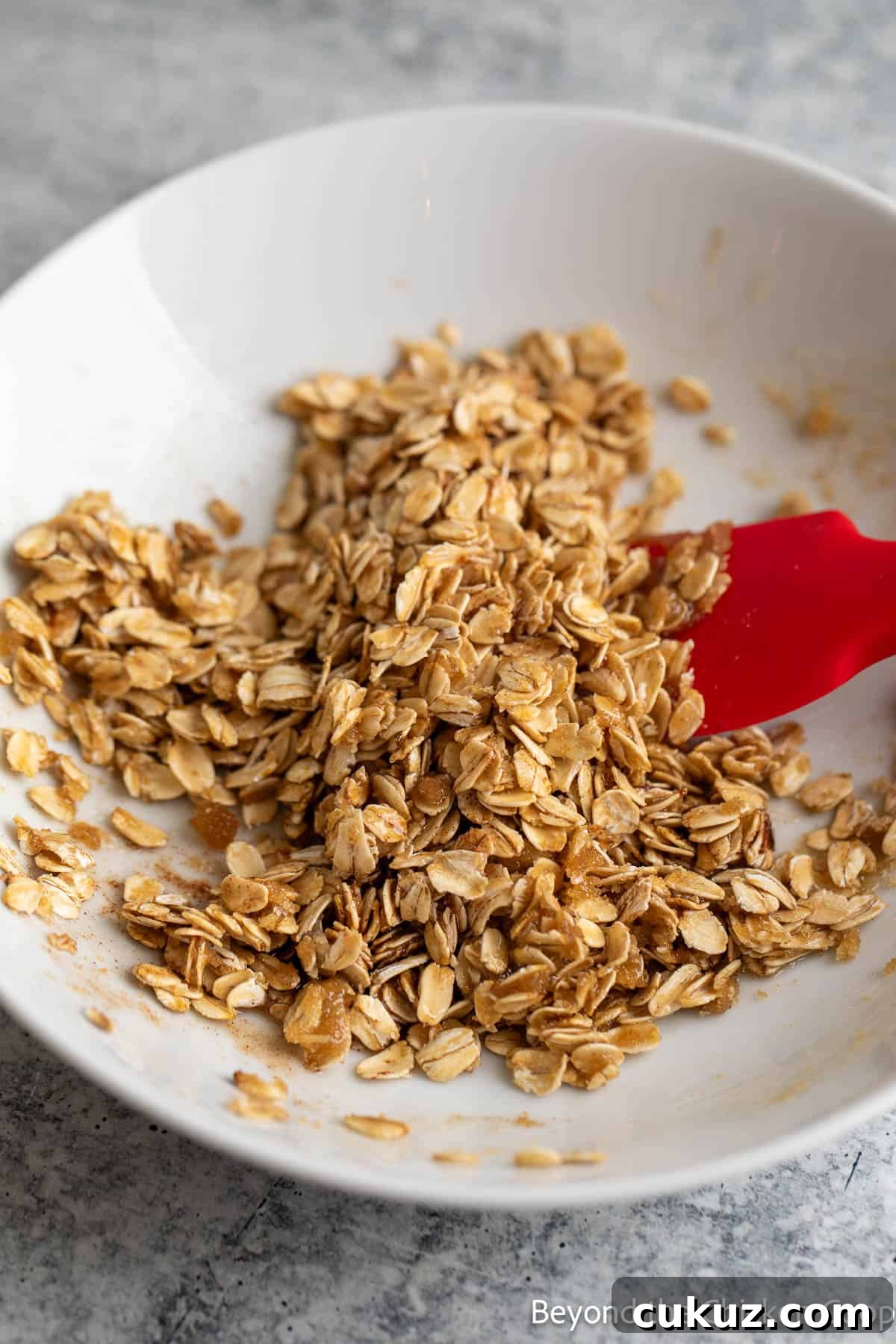 Oat topping mixed with butter and sugar in a white bowl. 