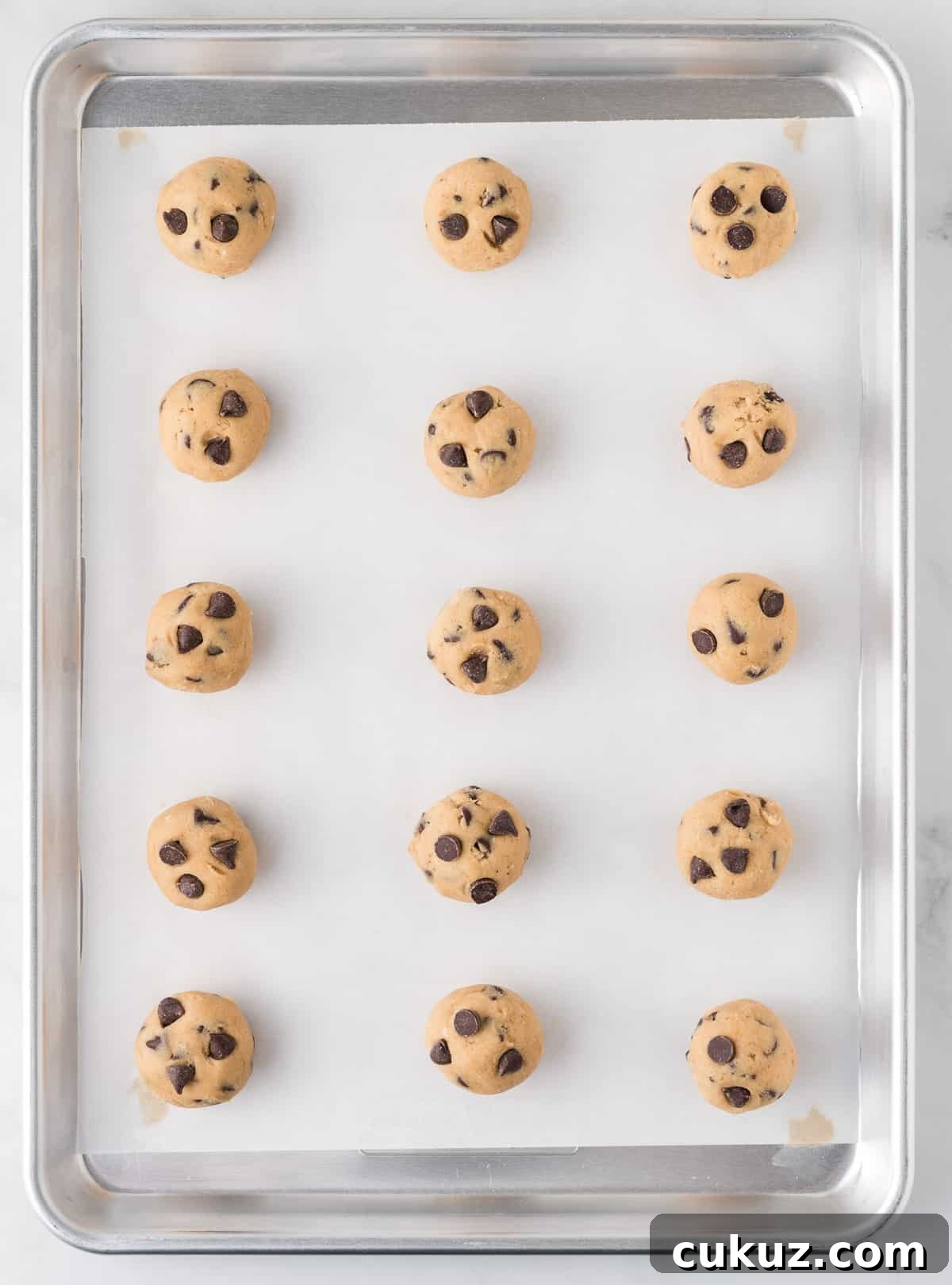 balls of cookie dough on a baking sheet