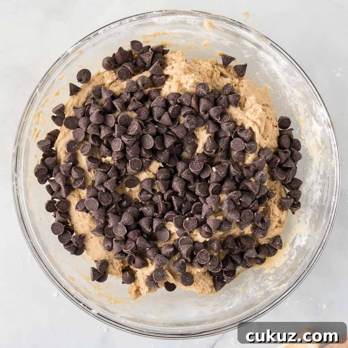 adding the chocolate chips to the cookie dough
