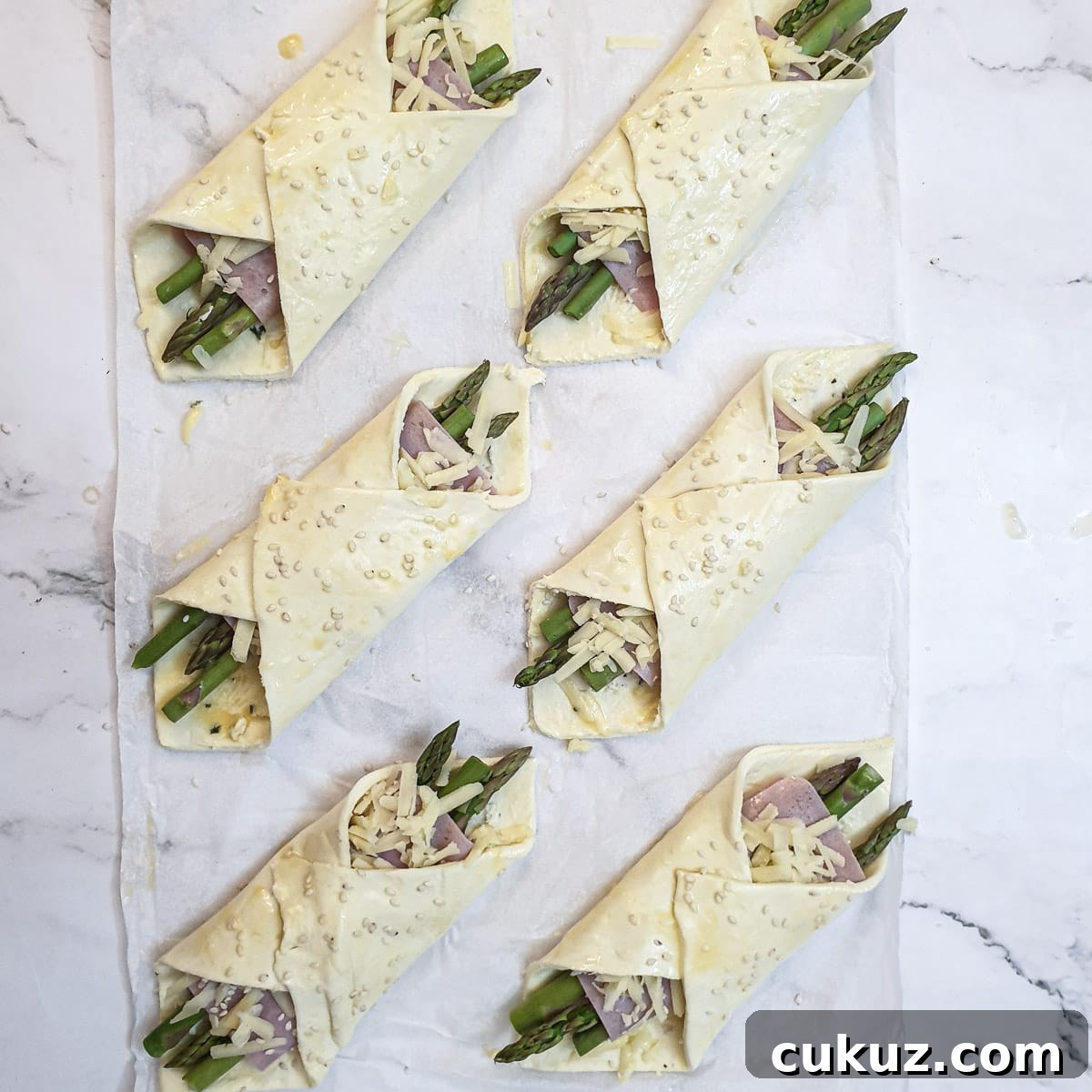 6 fully assembled asparagus and ham wraps.