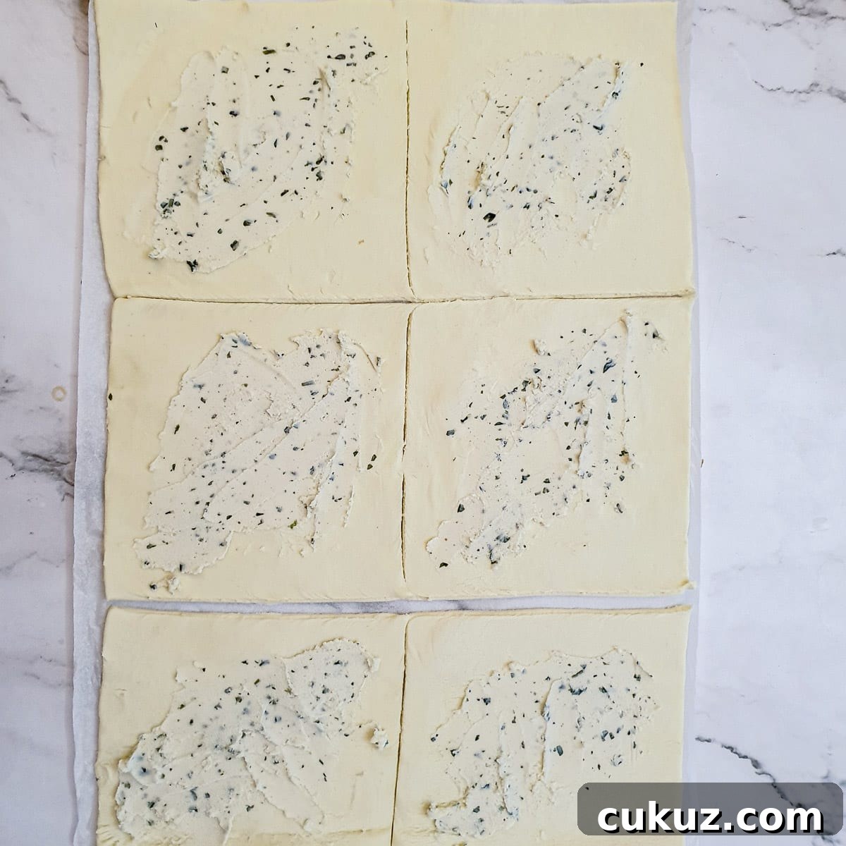 6 squares of puff pastry spread with garlic and herb flavoured cream cheese.