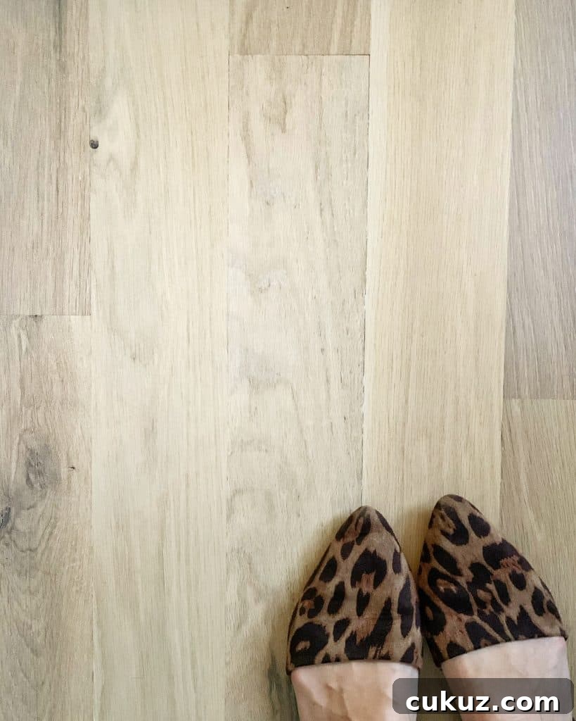 White Oak Flooring Guide: Selection, Installation & Care 7 white oak hardwood floors with leopard print shoes peeking out