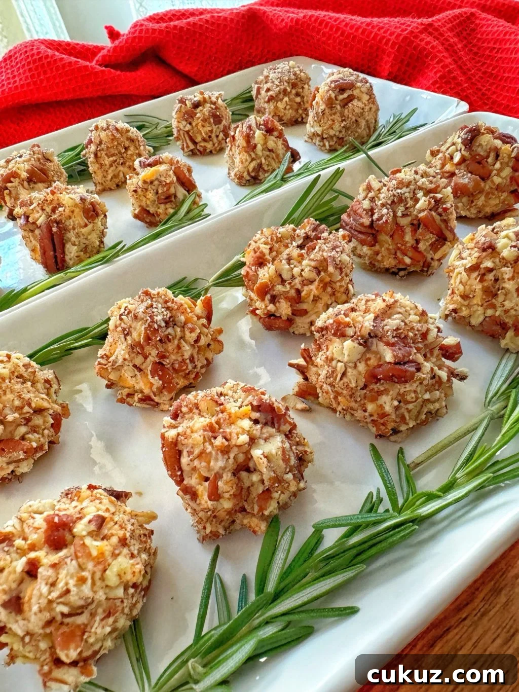 Bite-Sized Cheesy Snack Balls: Party Appetizer Recipe 2 Cheese ball appetizers on a rectangular white plate.