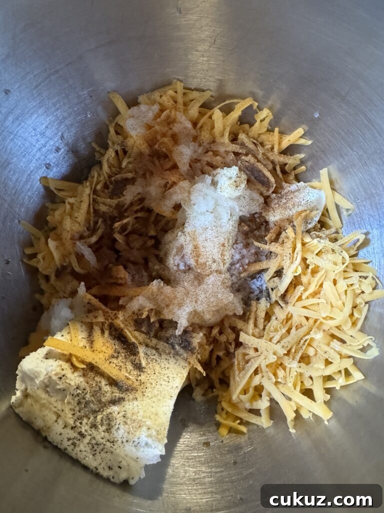 Bite-Sized Cheesy Snack Balls: Party Appetizer Recipe 4 The cheese ball ingredients in a metal bowl.