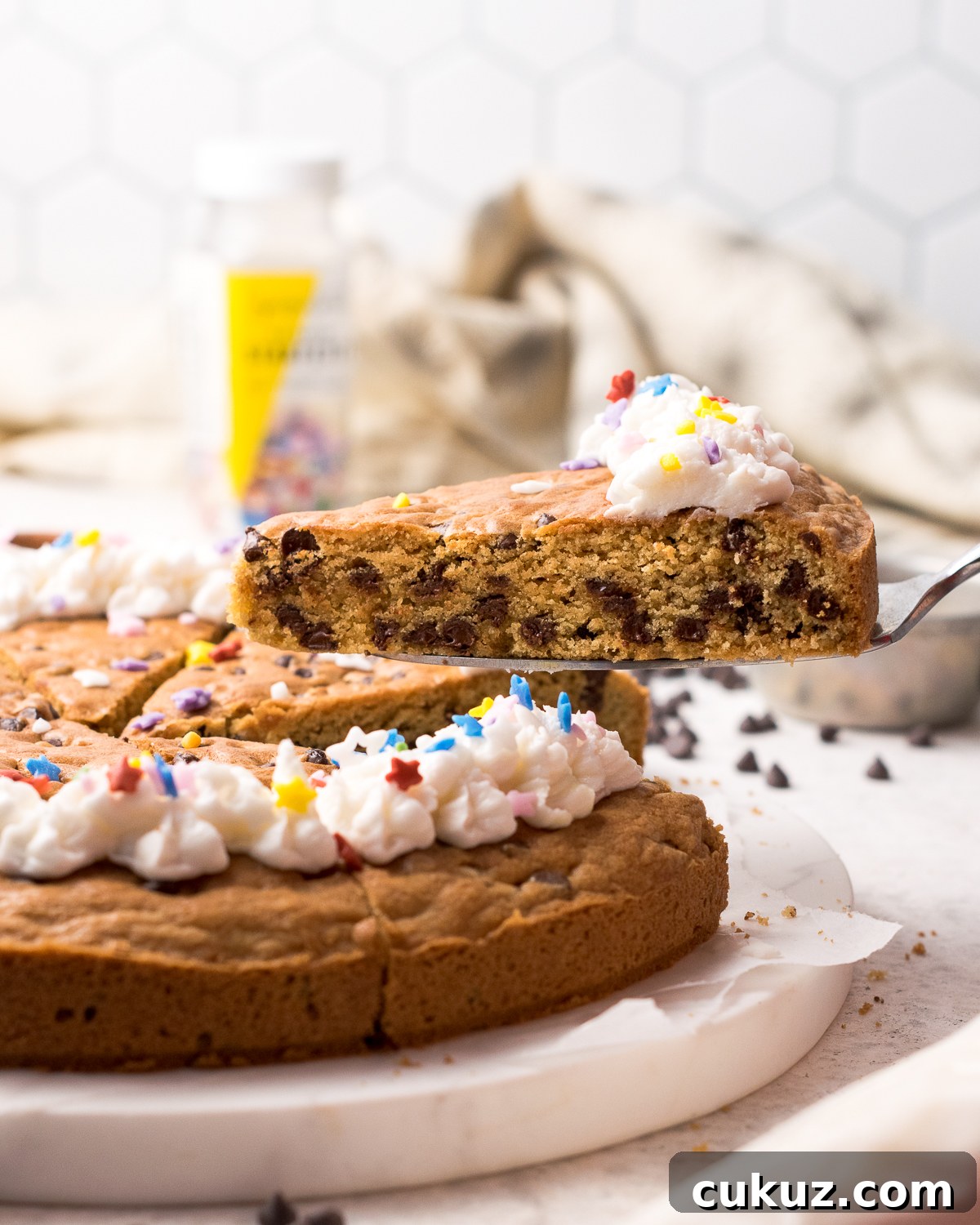 A slice of gluten free cookie cake being served.