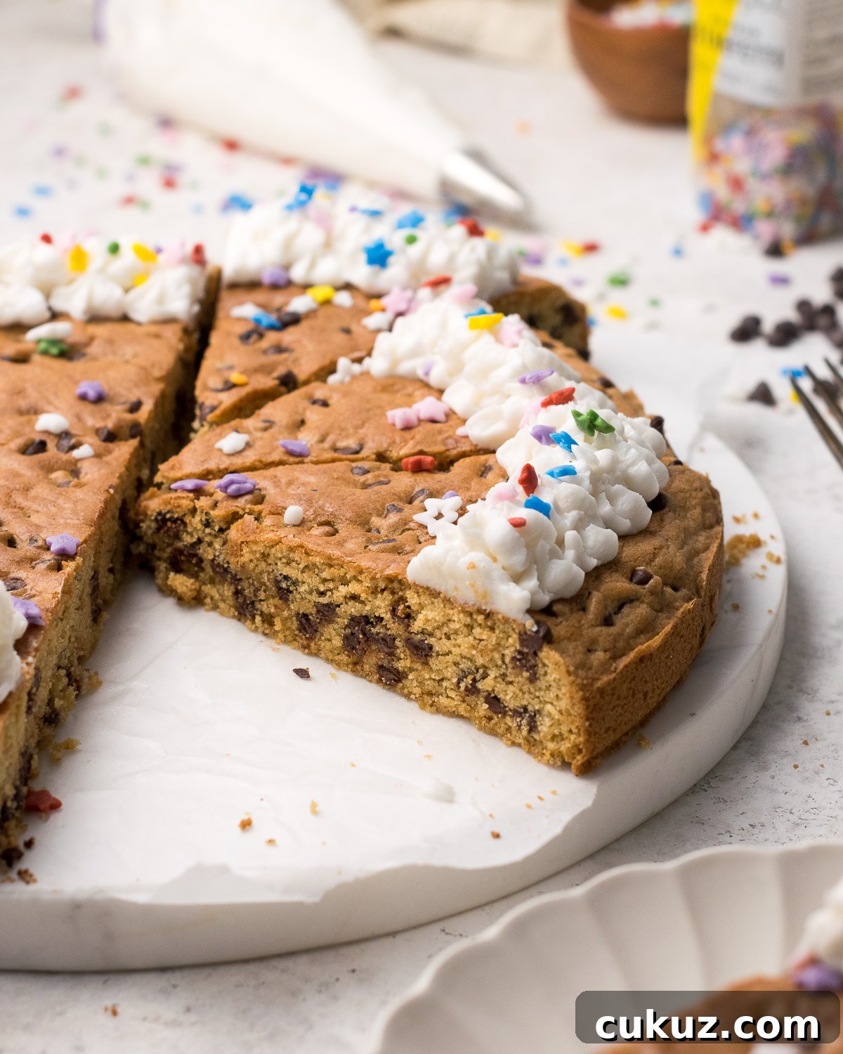 Cut cookie cake on a white tray.