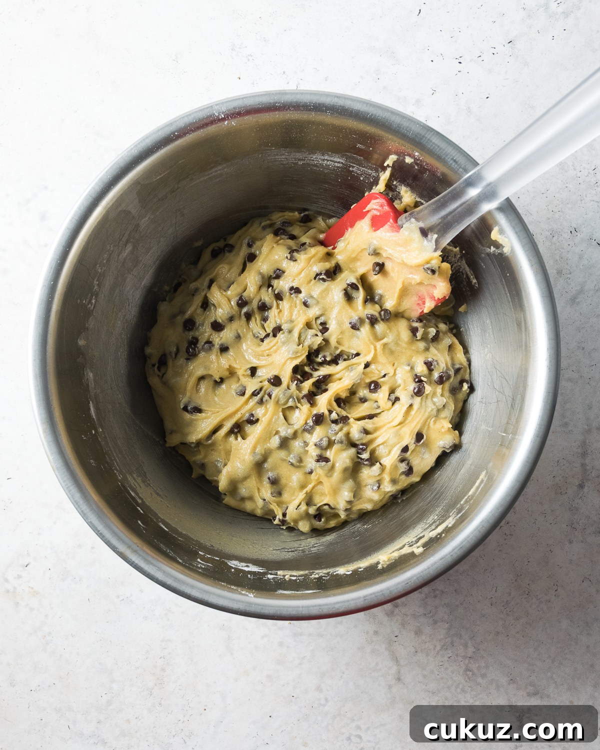 Cookie batter in a metal bowl.