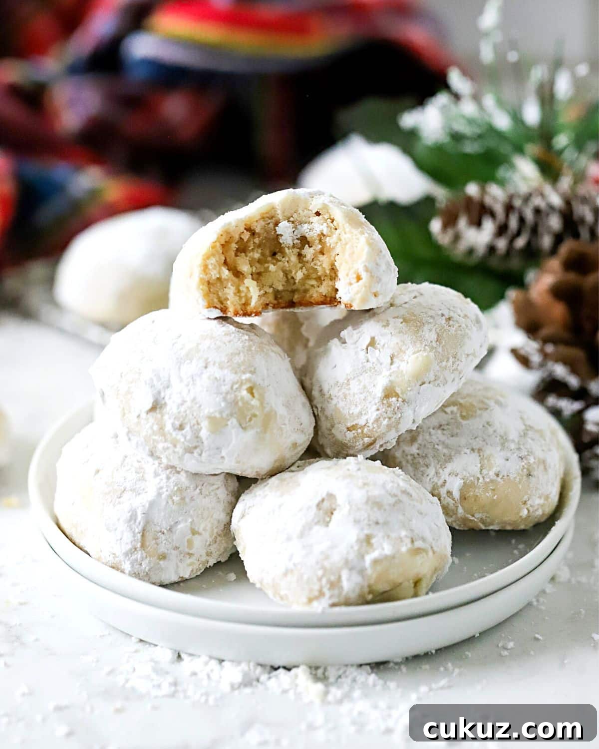 Classic Snowball Cookies Recipe for Perfect Holiday Cookies 3 Snowball cookies stacked on a plate.
