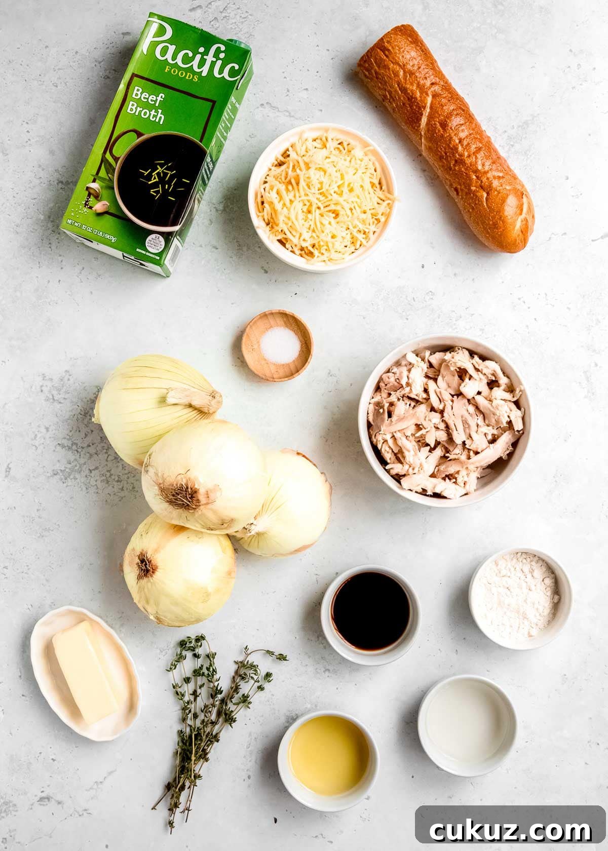 all ingredients needed for french onion chicken soup on a white countertop