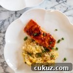 Scalloped plate with salmon and rice.