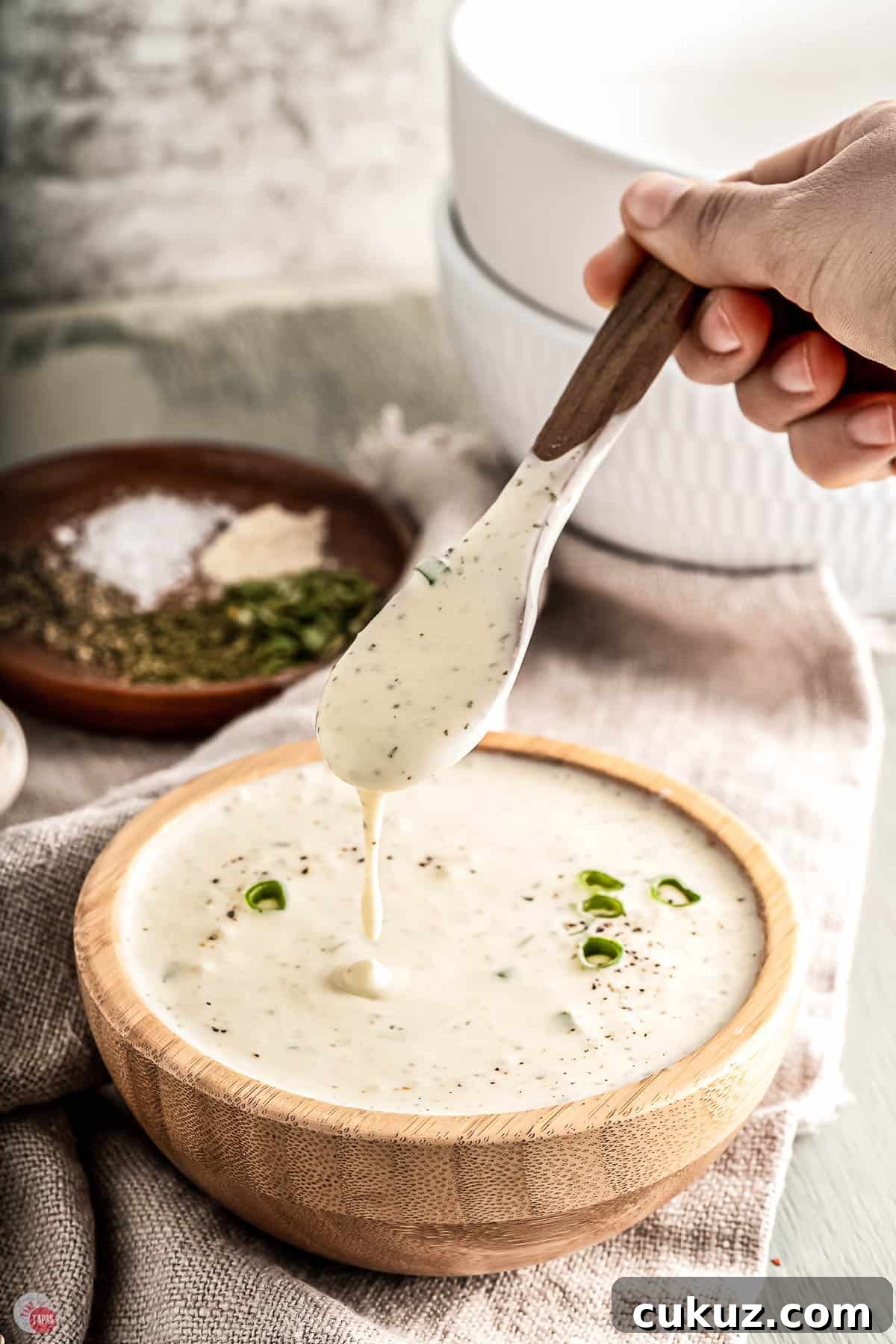 ranch sauce in a wood bowl with a spoon