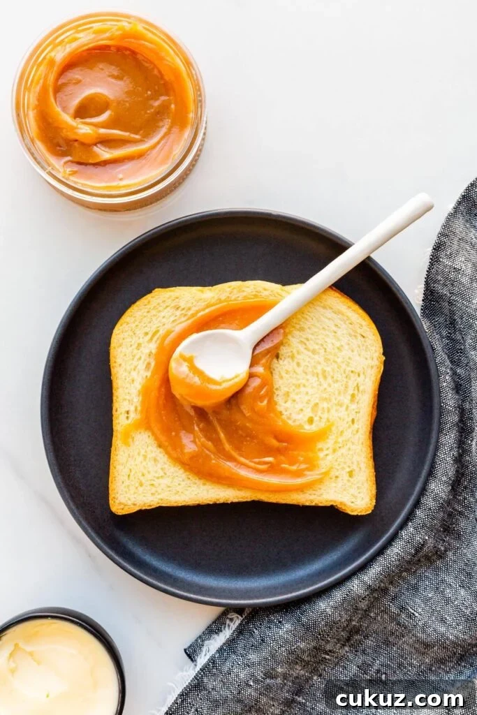 A slice of brioche with homemade dulce de leche smeared on it.