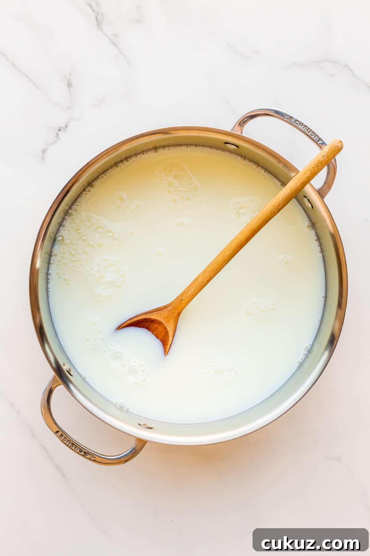A pot of milk and sugar ready to be cooked to make milk jam or dulce de leche.