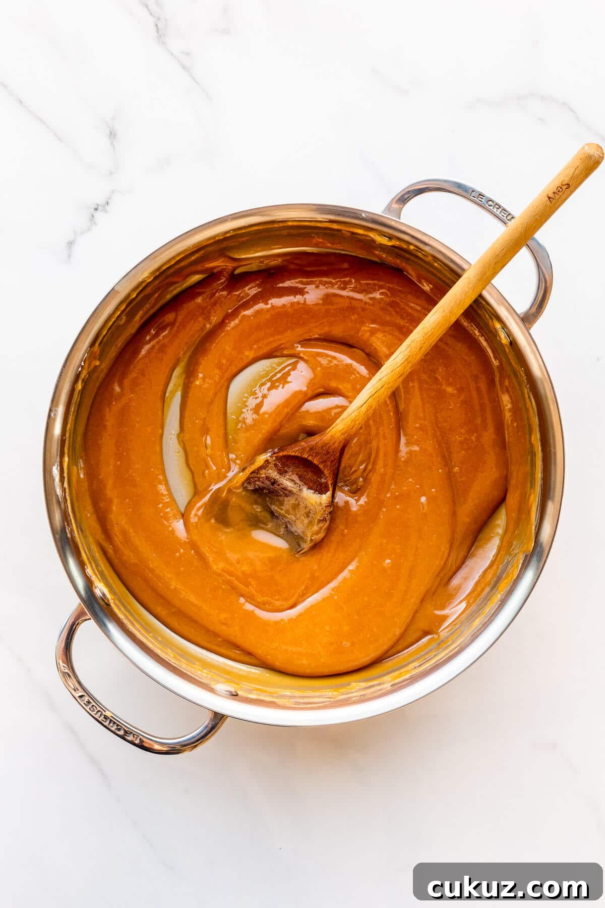 A pot of homemade dulce de leche freshly made and ready to transfer to a jar.