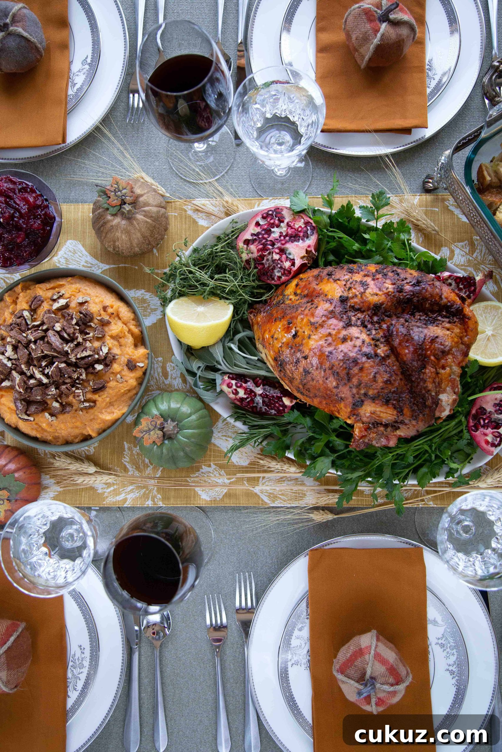 Mashed Sweet Potatoes with Cinnamon-Spiced Pecans 5 Thanksgiving tablescape with a bone-in turkey breast, mashed sweet potatoes, mini faux pumpkins, and china.