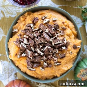Mashed Sweet Potatoes with Cinnamon-Spiced Pecans 6 a green bowl filled with mashed sweet potatoes, topped with candied pecans.