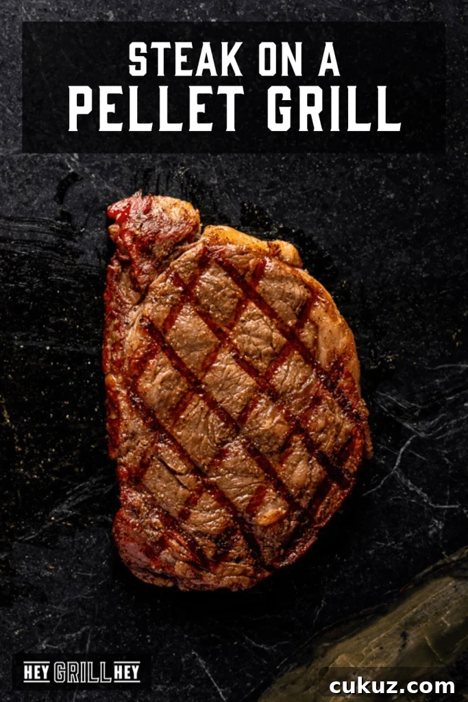 Steak on a dark serving platter with text overlay - Steak on a Pellet Grill.
