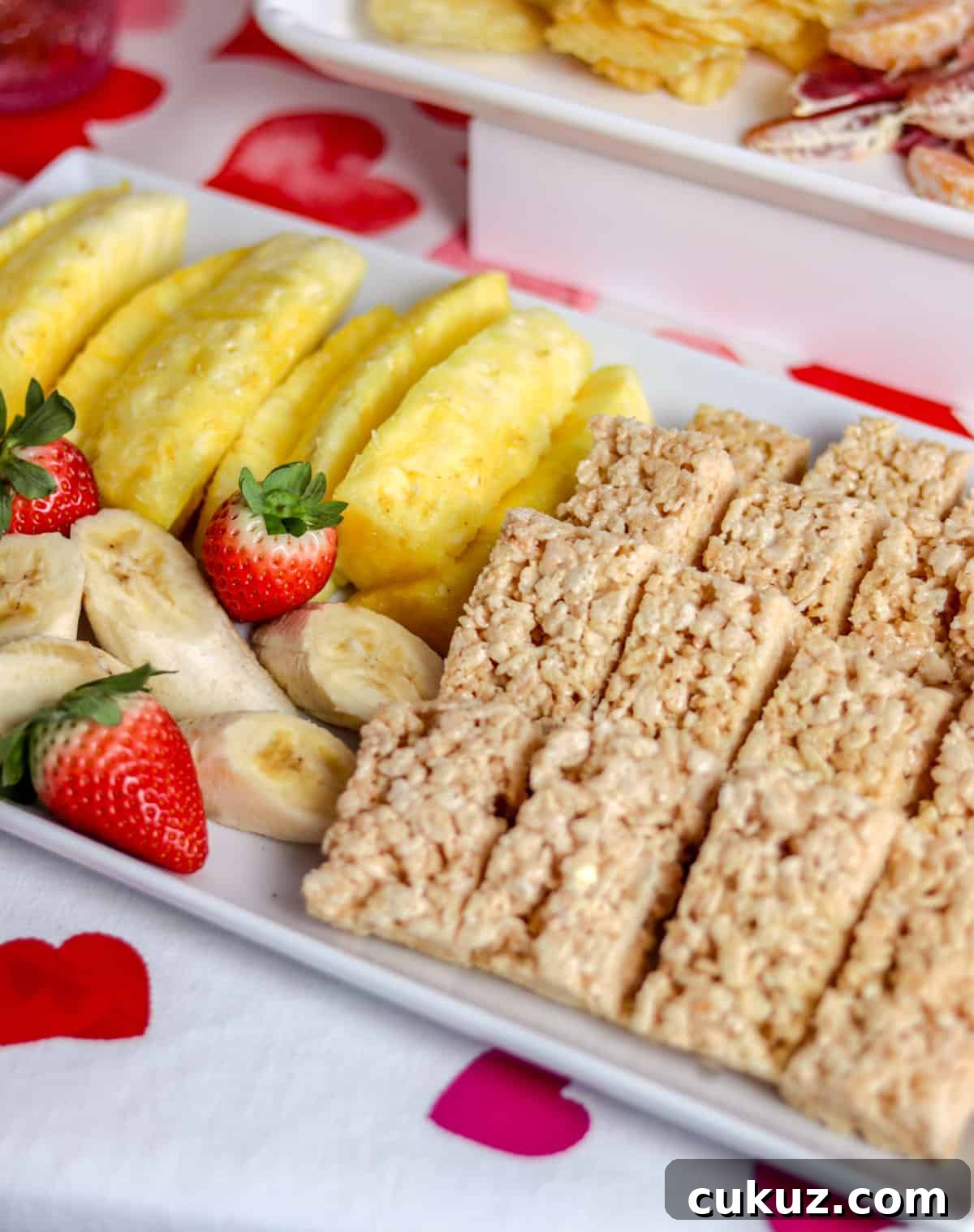 Pineapple, rice crispy treats and bananas on plate.