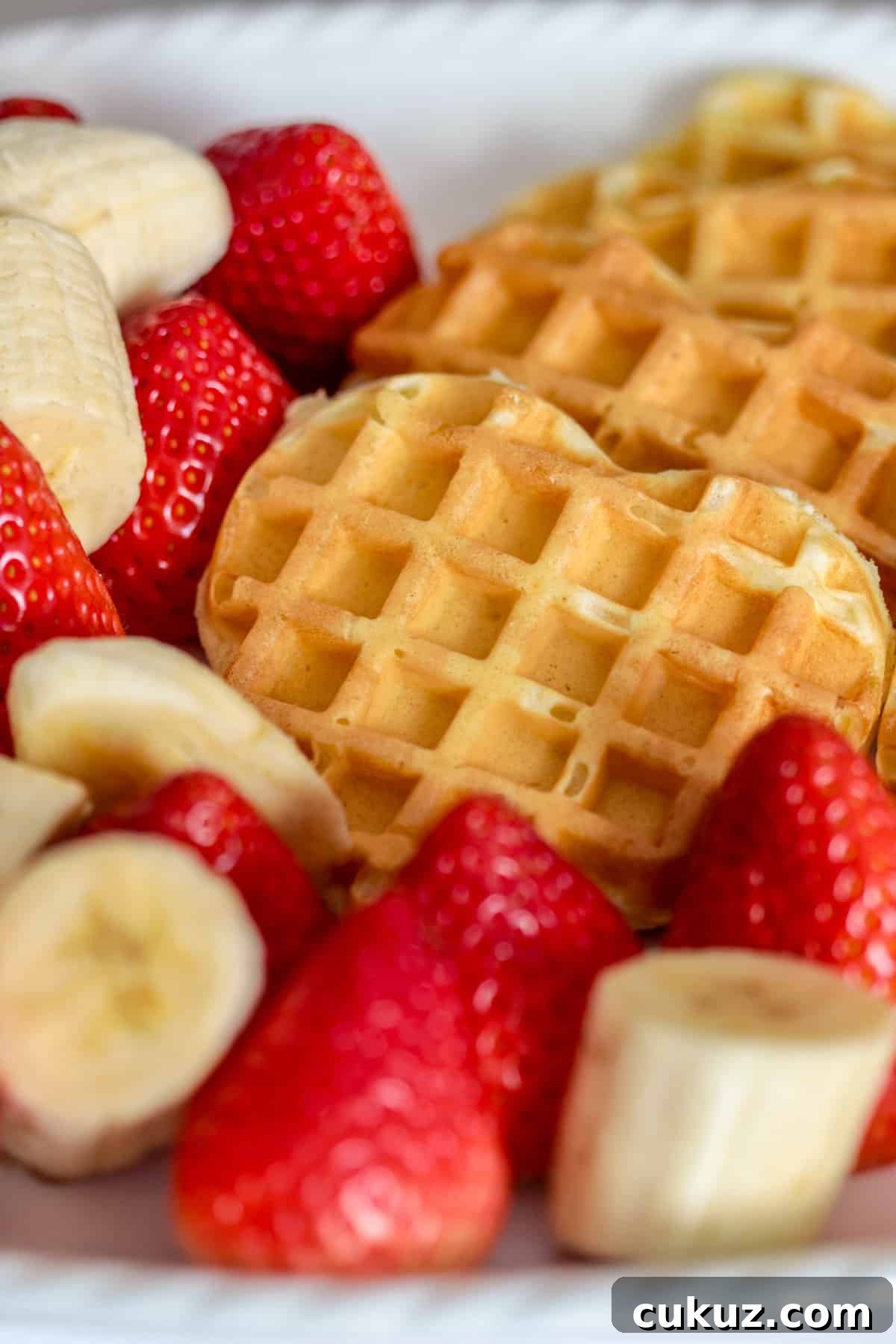 Heart shaped waffles and strawberries.