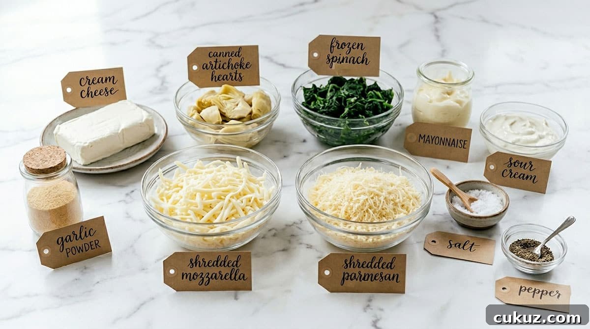 Creamy One‑Bowl Spinach and Artichoke Dip Recipe 3 Ingredients for recipe on white marble background.