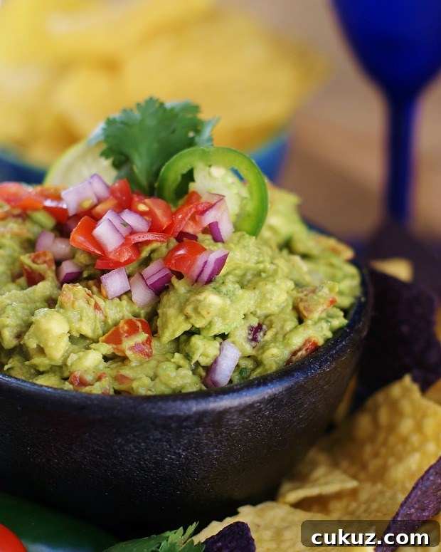 Fresh guacamole in a black bowl.