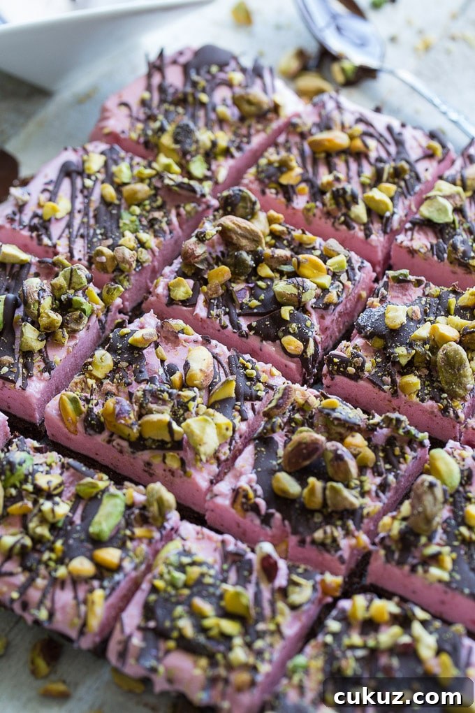 Up-close view of Frozen Strawberry Goat Cheese Bars cut into squares.