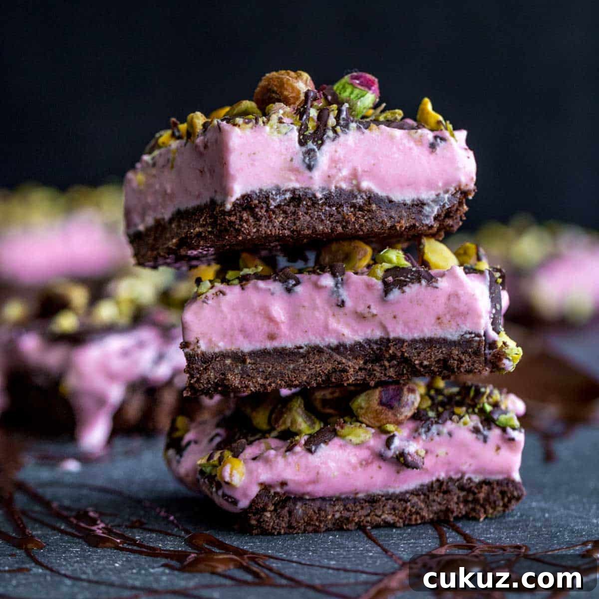 Side view of a stack of strawberry goat cheese bars.