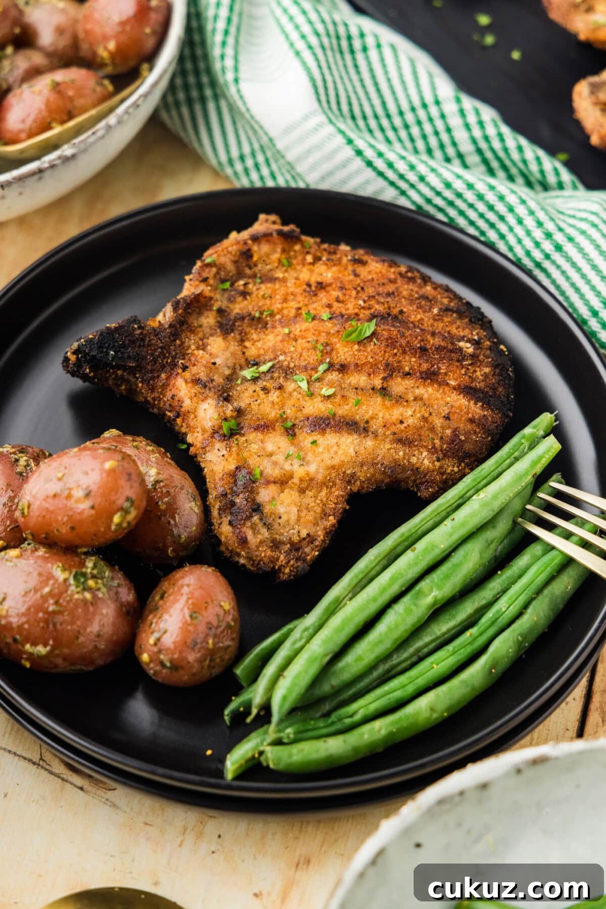 Crispy Grilled Breaded Pork Chops Recipe 3 Grilled Breaded Pork Chop on plate with green beans and potatoes