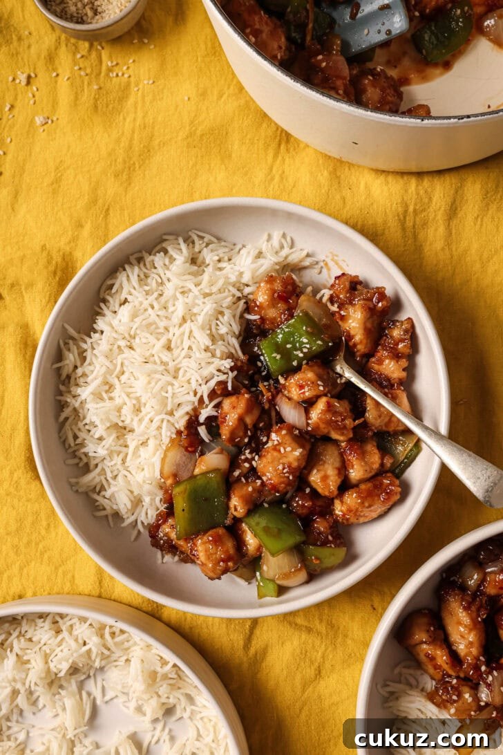 A plate of Honey Ginger Chicken with rice ready to be eaten.