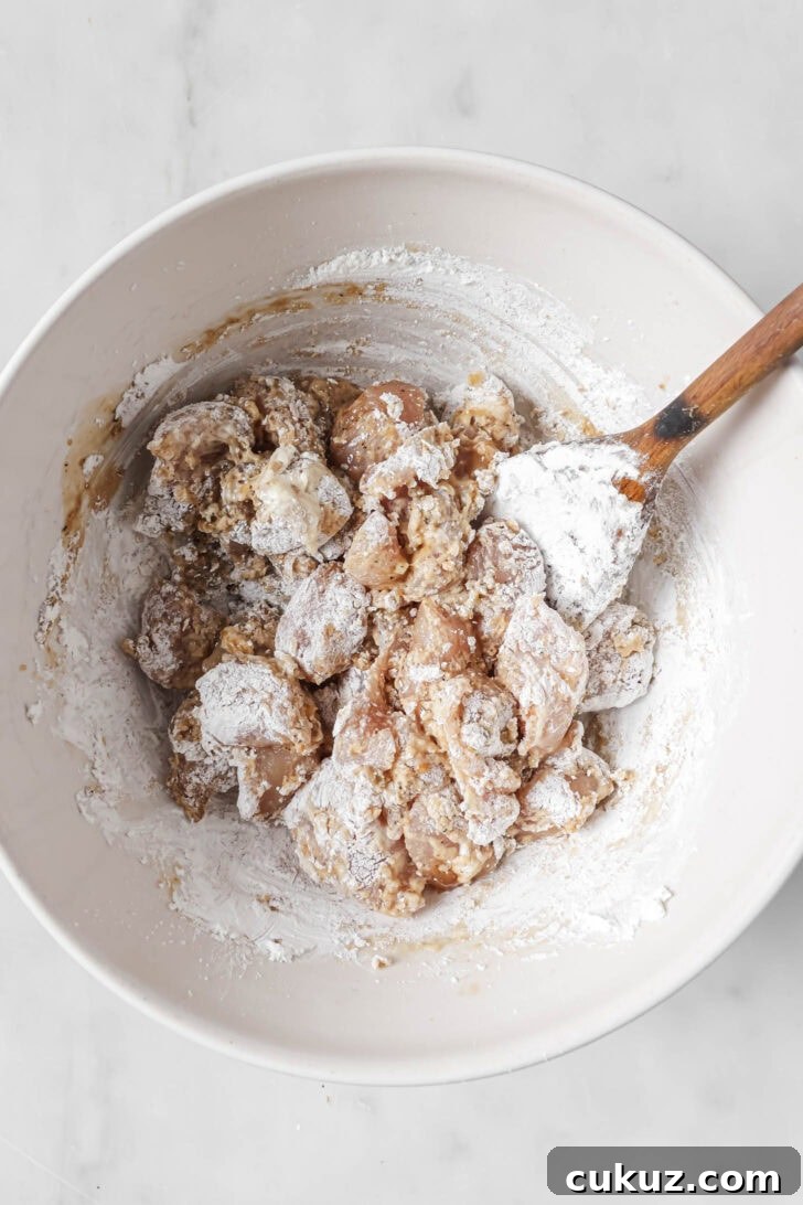 Marinated chicken tossed with cornstarch and flour to make Honey Ginger Chicken.