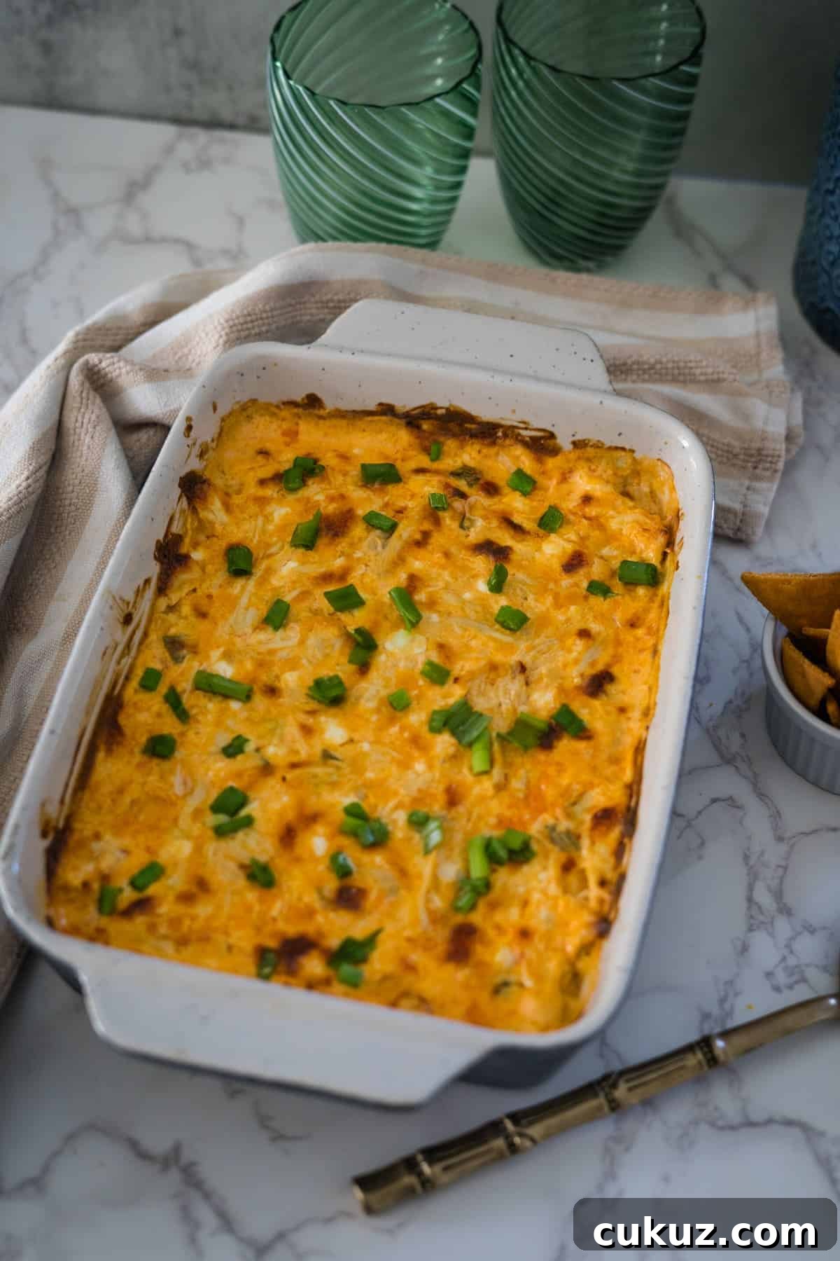 Cheesy cheesy dip in a white dish.