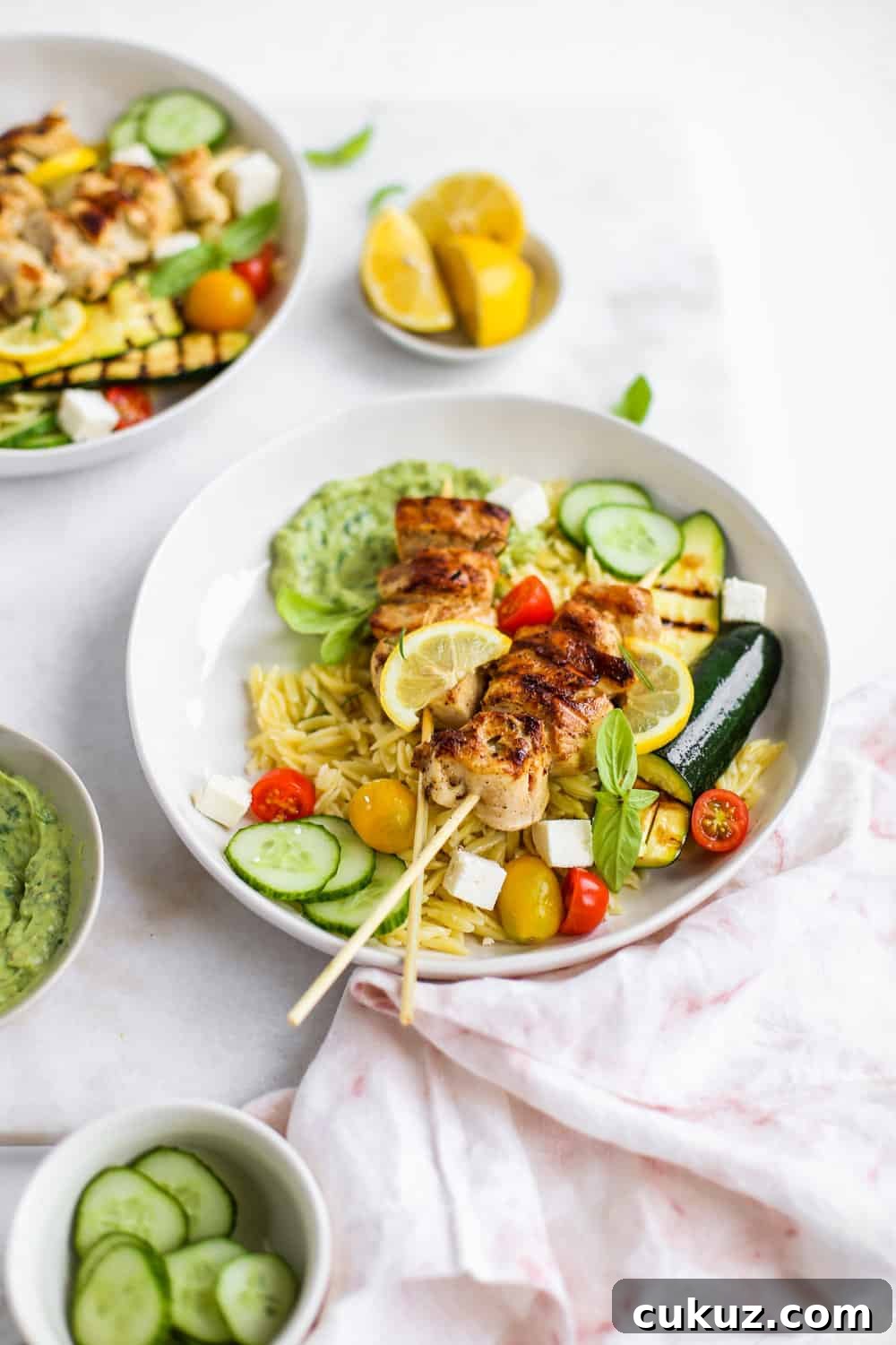 Lemon Garlic Chicken Skewer Bowls with orzo and green goddess dressing in a white bowl